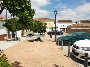 a parking lot with cars parked on a street at Acogedora casa cerca de Córdoba in Encinarejo De Córdoba