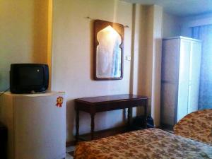 a hotel room with a bed and a television at Orchida St. George Hotel in Aswan