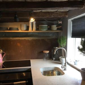 a kitchen counter with a sink and a window at Watt Cottage in Ipswich
