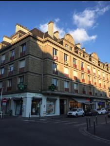 un gran edificio con coches estacionados frente a él en Appartement FACTORY, en Lorient