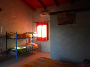 a room with two bunk beds and a window at Agriturismo Su Nuratolu in Sagama