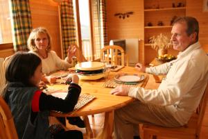 a group of people sitting around a table at La Moraine in Villard-de-Lans