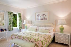 a bedroom with a large bed and two lamps at Cobblers Cove - Barbados in Saint Peter
