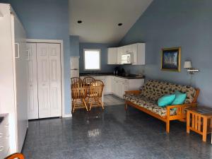 a living room with a couch and a kitchen at Ocean Walk Hotel in Old Orchard Beach