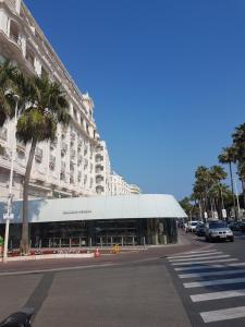 a building with a white awning next to a street at Valentina 16/18 Rue rouaze cannes in Cannes