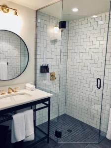 a bathroom with a sink and a shower at The Ramble Hotel in Denver