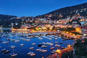 a harbor with boats in a city at night at Affittacamere La Baia Di Lerici in Lerici