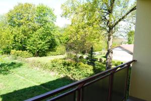 a balcony with a view of a yard at U Huberta in Wrzosowo