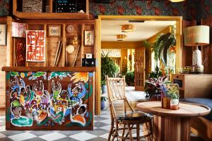 a room with a table and a painting on the wall at Freehand New York in New York