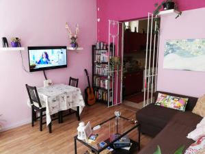 A television and/or entertainment centre at Aloi Rooms