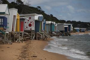 a beach with a row of boats parked on it at Mt Martha Villas in Mount Martha