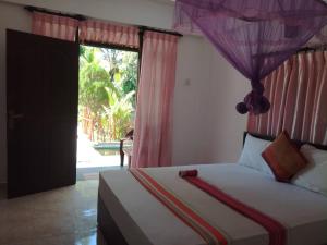 Voodi või voodid majutusasutuse Sigiriya River Side Resort toas