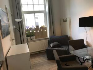 TV a/nebo společenská místnost v ubytování Apartment am Wall