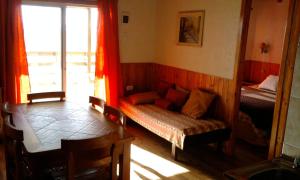 a living room with a couch and a window at Cabañas del Rio - La Pesca - Region del Maule in Iloca