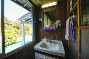 a bathroom with a sink and a window at Momonga Village in Miyoshi +106 photos