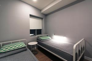 a bedroom with two bunk beds and a window at Blueboat Hostel Haeundae in Busan