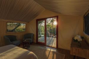 a bedroom with a bed and a sliding glass door at Sanctuary by Sirromet in Mount Cotton