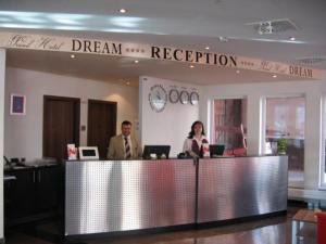 a man and a woman sitting at a reception desk at Grand Hotel Dream Main City Center in Frankfurt