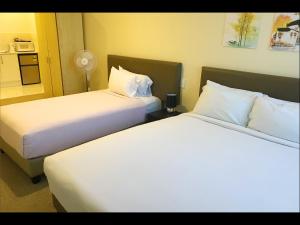Postel nebo postele na pokoji v ubytování Grand Central Serviced Apartments