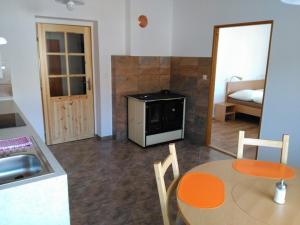 a kitchen with a table and a sink and a table and chairs at Penzion Pod Jáchymem in Dobrá Voda +17 photos