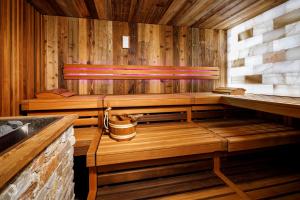 an empty sauna with wooden walls and a window at Eiger Mürren Swiss Quality Hotel in Mürren