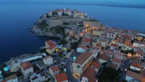 an aerial view of a city at night at Hôtel Méditerranée in Calvi