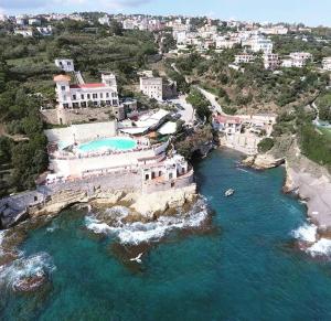 an aerial view of a resort with a body of water at Residence Posillipo in Naples