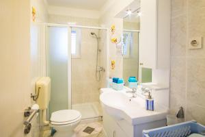 a bathroom with a toilet and a sink and a shower at Apartments Stasic in Vrbnik