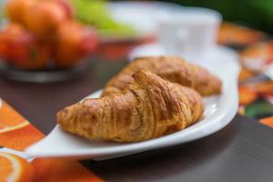 two croissants on a white plate on a table at Apartments Stasic in Vrbnik