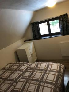 a small bedroom with a bed and a window at Chalupa Dolce Vita in Trutnov +64 photos