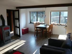 a living room with a table and chairs and a fireplace at Chalupa Dolce Vita in Trutnov