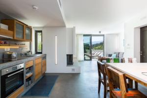 a kitchen with a table and a dining room at Elea Villas - Aspro & Blanche in Almyrida +59 photos