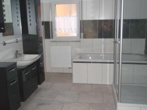 een badkamer met een douche, een wastafel en een bad bij Ferienwohnung am Schloßberg in Arnstadt