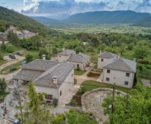 an aerial view of a village with mountains in the background at Althea Guesthouse in Ano Pedina