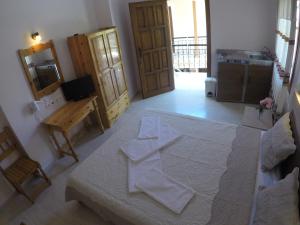 a bedroom with a large white bed in a room at Geroulis Stefanos Studios in Vasiliki +34 photos
