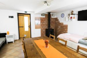 a living room with a table and a bedroom at Amber Studio Apartment Alpine Retreat Soča Valley in Kobarid