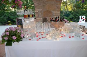 a table with wine glasses and flowers on it at Residence Sant'Alessandro in Settecamini