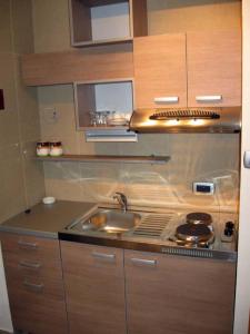 a kitchen with a sink and a stove at Apartmani Katarina in Budva