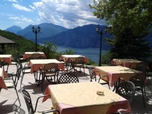 a group of tables and chairs with a view of a lake at Agriturismo San Maggiore in Malcesine