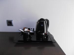 a coffee pot sitting on a stove with two cups at Hotel Marblau Tossa in Tossa de Mar