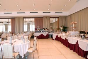 a banquet hall with tables with white tablecloths at Grand Hotel Savoia in Genoa +37 photos