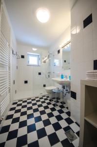 a bathroom with a black and white checkered floor at Apartments Vila Marjetica in Bled +59 photos