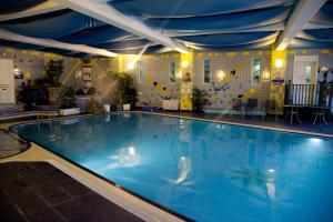 a swimming pool with a pool table and chairs at Hotel Rendezvous - Skipton - N Yorkshire in Skipton