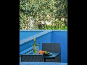 a table with a bottle of wine and a plate of fruit at Pan Mare in Skala Sotiros +21 photos