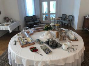 a white table with food on top of it at Gästehaus Leipzig in Leipzig