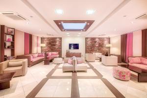 a waiting room with pink furniture in a hospital at Hotel LIVVO Volcán Lanzarote in Playa Blanca
