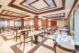 a restaurant with tables and chairs and a ceiling at Hotel LIVVO Volcán Lanzarote in Playa Blanca