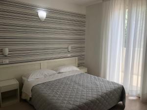 Postel nebo postele na pokoji v ubytování Hotel Stella Polare