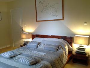 a bedroom with a bed with pillows and two lamps at GUTKOWSKI Jacqueline in Saint-Philbert-de-Bouaine +22 photos