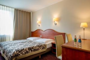 Posteľ alebo postele v izbe v ubytovaní Hotel Krakus